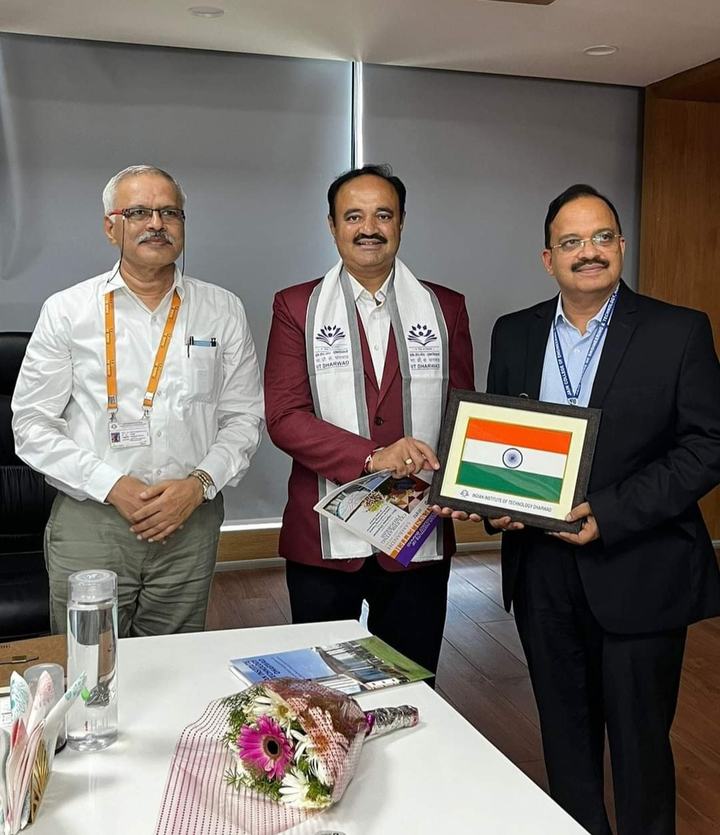 Dr Hegde receiving a framed Indian flag at IIT Dharwad